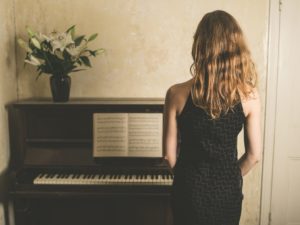 Woman at Piano Studying Richard J. Chandler's 5 Evening Pieces for Piano